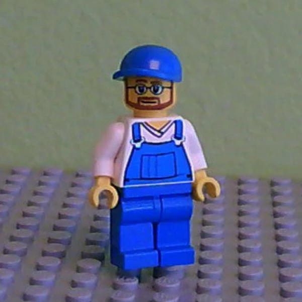Overalls Blue over V-Neck Shirt, Blue Legs, Blue Short Bill Cap, Beard and Glasses