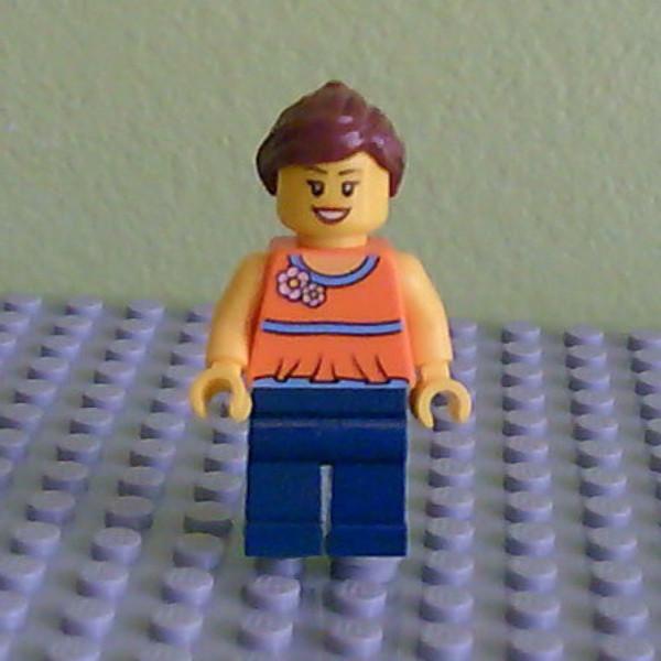 Orange Halter Top with Medium Blue Trim and Flowers Pattern, Dark Blue Legs, Reddish Brown Ponytail and Swept Sideways Fringe